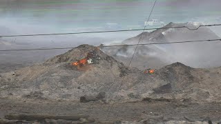Firefighter can't stop large pile of burning Hurricane Ida debris