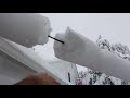 Snow tube around a telephone wire going into a house