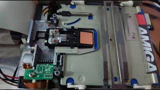 Amiga floppy drive goes about its business with no lid. Freshly cleaned heads on an A1200