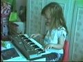 A very small licia missori playing keyboards