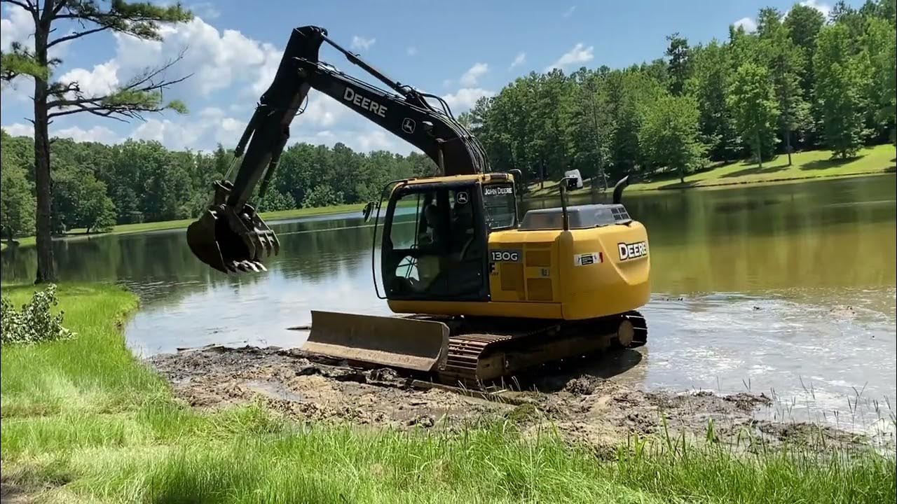 Dredging a pond with a Deere 130G excavator and swamp mats YouTube