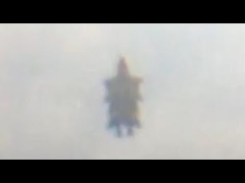 Flying Humanoid Figure Filmed In The Sky Over Maryhill In Glasgow, Scotland.