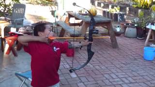 Max shooting his PSE Nova Jr compound bow from the flea market at age 6