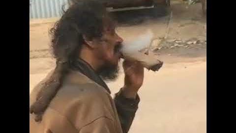 Jamaica rasta man smoking brown paper wee.