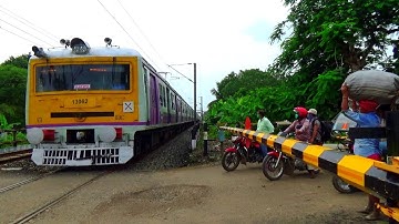 12 coach staff special EMU trains swiftly passing through busy level crossing