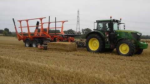 John Deere 6195R & Big Bale Transtacker chasing bales.