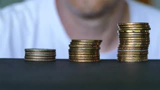 Man Stacking Up Coins Stock Video