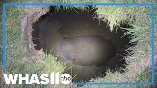 Rescuers reassess the safety of their search for a woman they believe fell into a sinkhole