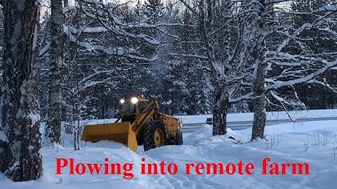 Snow plowing into a remote farm in Arctic Lapland