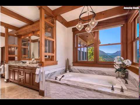 rustikales-badezimmer-mit-stein-badewanne-und-blick-über-die-berge