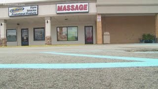 Feds, police search massage parlor