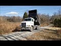 Dump truck tailgating gravel on Mile long driveway & beautiful views