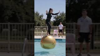 She hops across floating gold balls to cross a swimming pool#viralvideo #ytshorts #viral #usa #pool