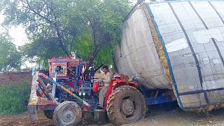 Trailer stock in mud pulled out with massey Ferguson Tractors