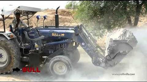 BULL v2 loader with booster bucket on Farmtrac  handling loading building material