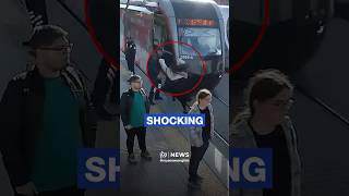 Hair-raising moment security guard saves woman from oncoming tram