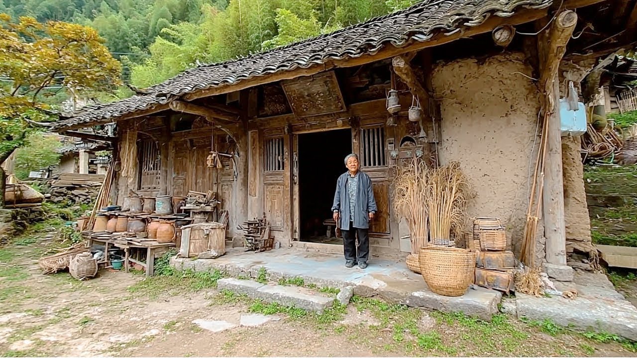 A man is renovating a dilapidated wooden hut left by his ancestors in a dense forest