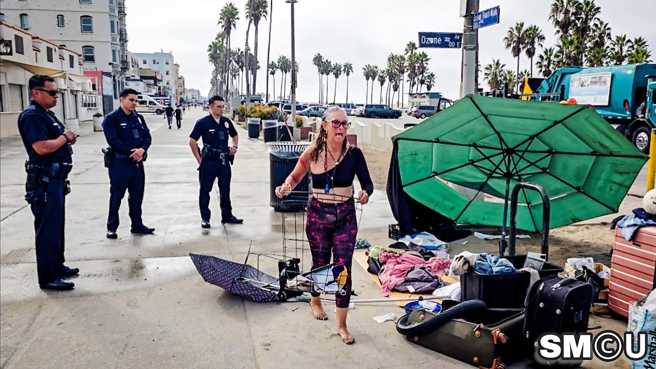 𝗛𝗢𝗠𝗘𝗟𝗘𝗦𝗦 𝗦𝗪𝗘𝗘𝗣: Police Order Unhoused Woman to Collect Belongings During Venice Cleanup Operation