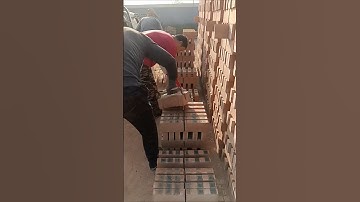 The process of loading red bricks for construction