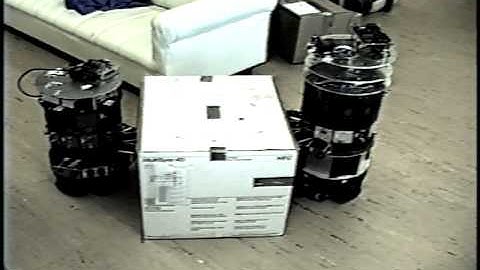 Distributed Manipulation with Mobile Robots, 1990-97: Pusher-steerer, the Sequel