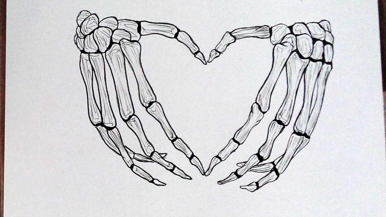 skeleton hand holding heart tattoo