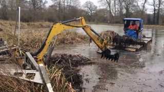 Truxor team work clearing aquatic weeds