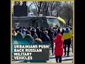 Watch the moment when Ukrainian civilians forced Russian military vehicles to turn around.