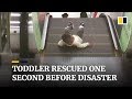Toddler rescued from escalator one second before disaster