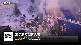 Fire crews work to put out a bleacher fire at a Gardena high school