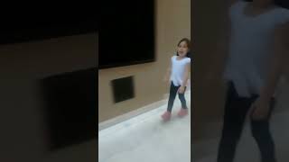 Girl rides Heelys down hill then falls forward and faceplants