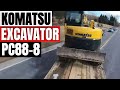 Picking up a Komatsu excavator with dump truck and tag trailer