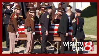 Pallbearers load casket for Cpl. Blake Reynolds into hearse after funeral
