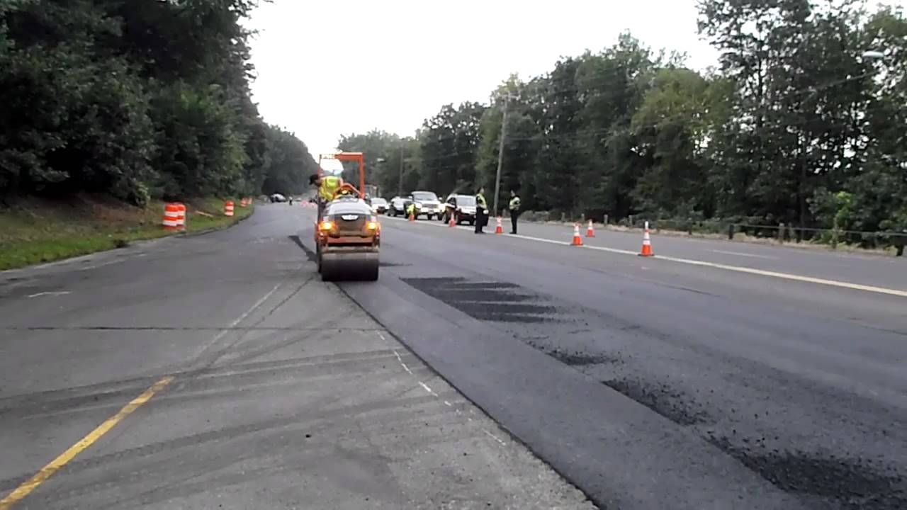 Asphalt roller compacting asphalt on a utility trench repair YouTube