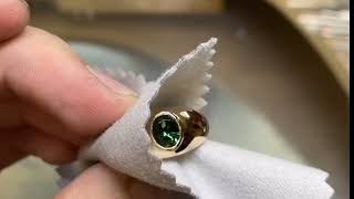 Resizing one of our one of one yellow gold green sapphire piece we size is it up 3.5