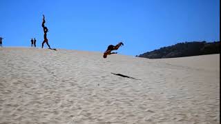 Guy Flips his way Down a Sand Dune - 1008127