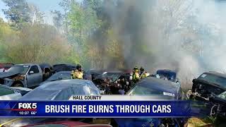 Brush fire burns through cars