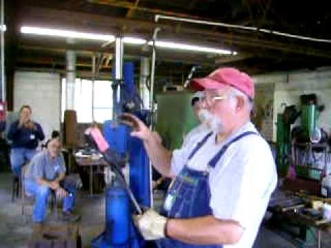 Blacksmith Eugene Ratliff forging hot cut hardy at...