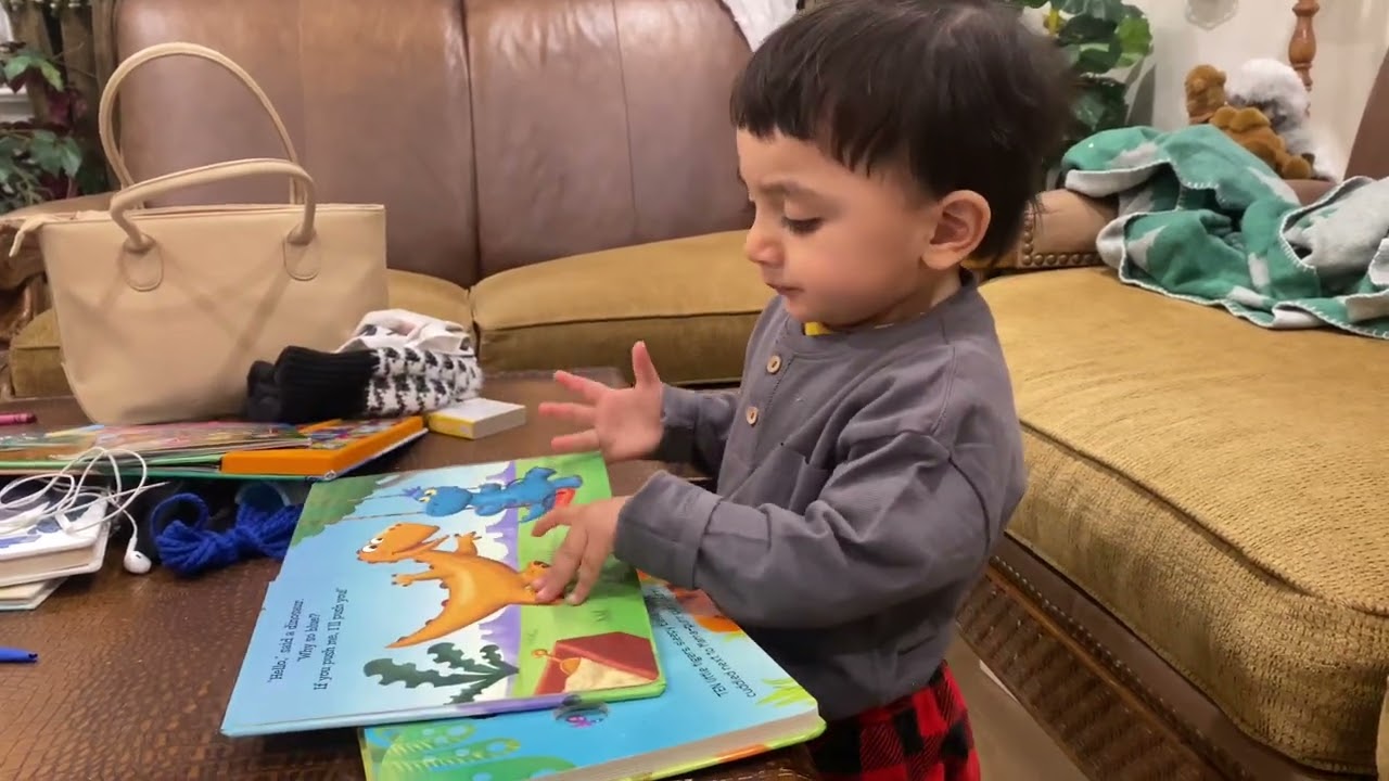 2 year old boy reading you Story book