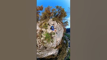 Sitting on top of a mountain after having climbed a fixed rope route - 360 camera live action