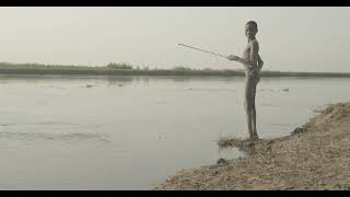 Mundari tribe boy fishing in river Nile, Central Equatoria, Terekeka, South Sudan