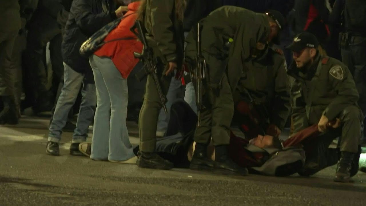 Israeli forces evacuate a man from an anti-government demonstration in Tel Aviv | AFP