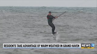 Surfers take advantage of warm windy weather in Grand Haven