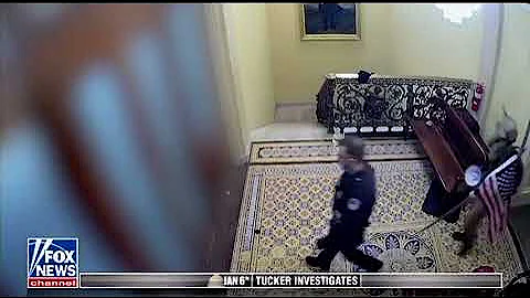 Qanon Shaman Jake Angeli led by police on tour guide through Capitol on January 6th