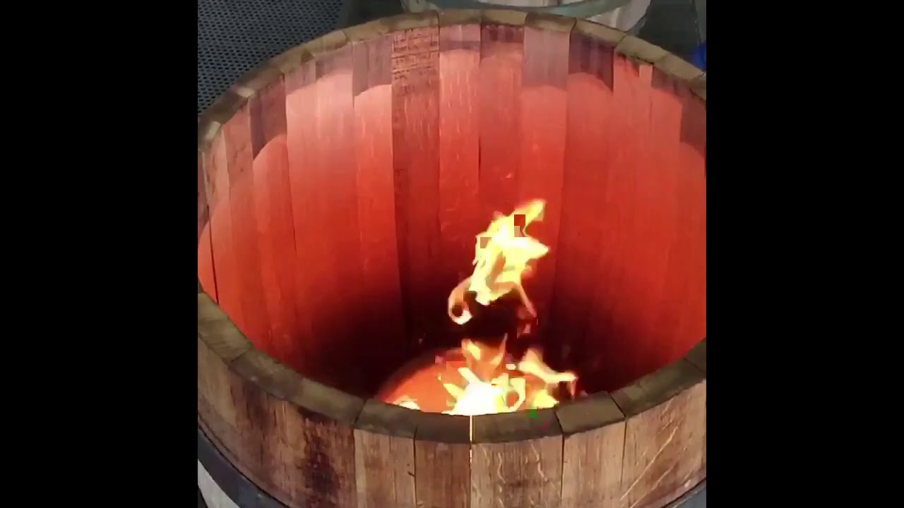 Toasting wine barrel slo-mo at Tonnellerie Cadus in Burgundy, France.