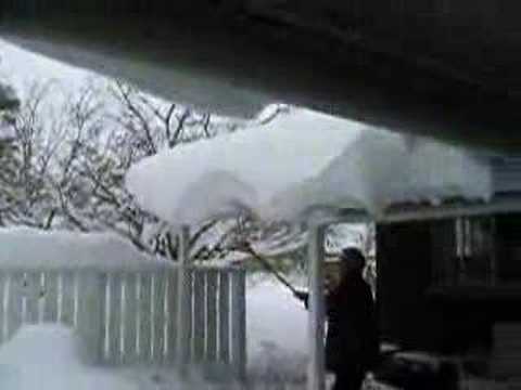 Marilyn wacks snow off the roof