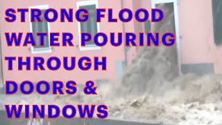 Insane Flooding! Unusually Strong flood water gushes through doors and windows of apartment building