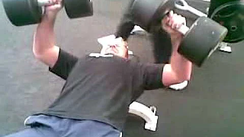 Stephen Neely doing 48kg dumb bell press in fitnes...