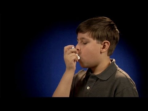 Using a metered dose inhaler one to two inches from mouth