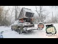 Solo rooftop tent camping in a snow storm