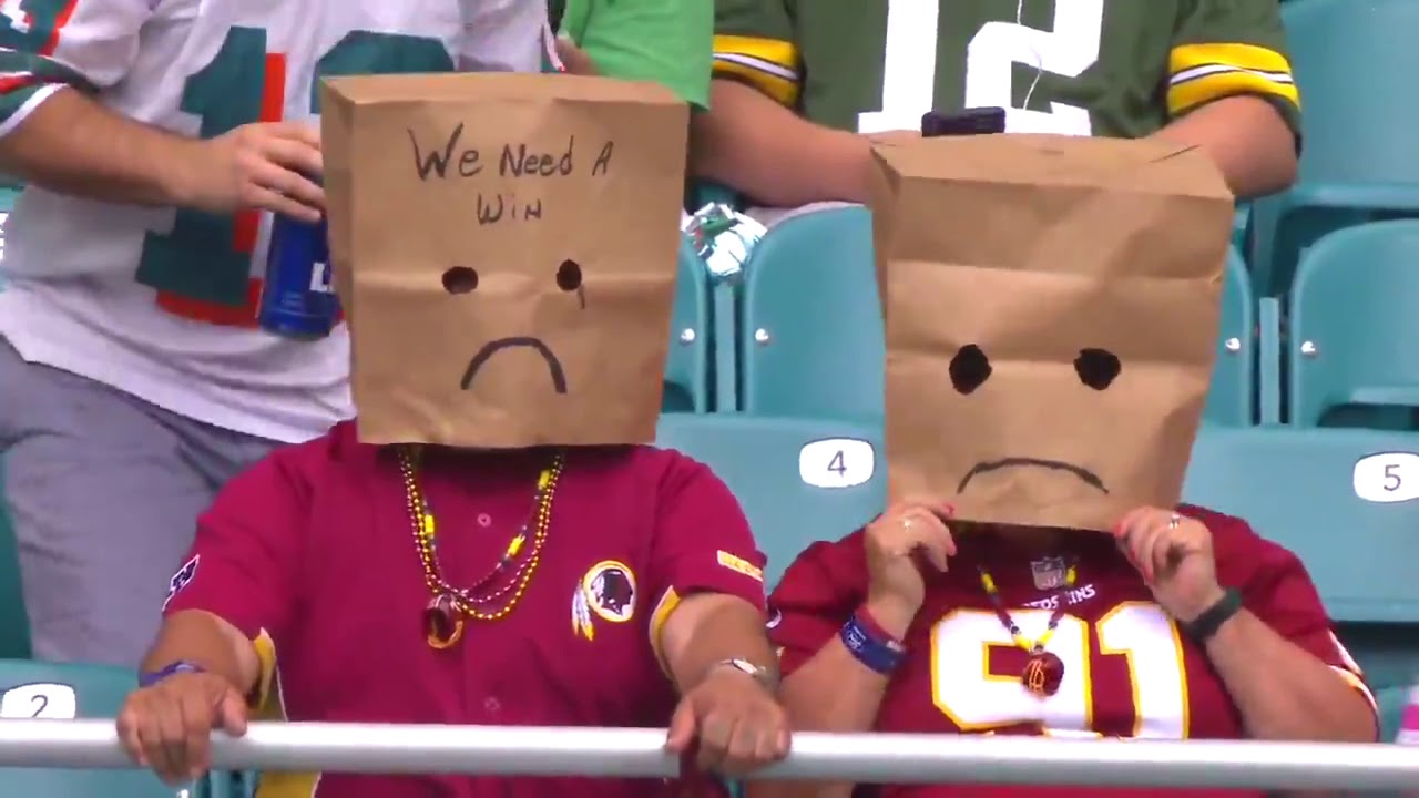 Redskins fans wearing paper bags over their heads before their game